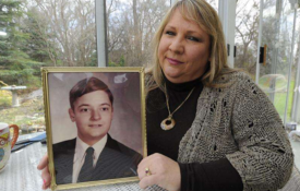  Pamela Oleander holding a photo of Johnny Trout
