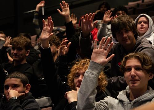 Students with Hands Raised Asking Question at PHS Jay Timmons Event