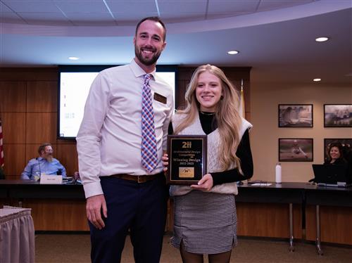 Photo of CAD Winner Emma Martchenkov Holding her Winners Plaque