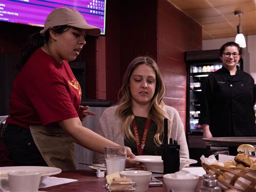 Students serves soup to Assistant Principal