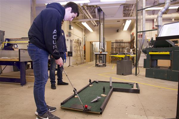 Woodworking students at Hoffman Estates built their own mini golf course, complete with the amenities we've all grown accustomed to at mini golf courses: like disco balls.